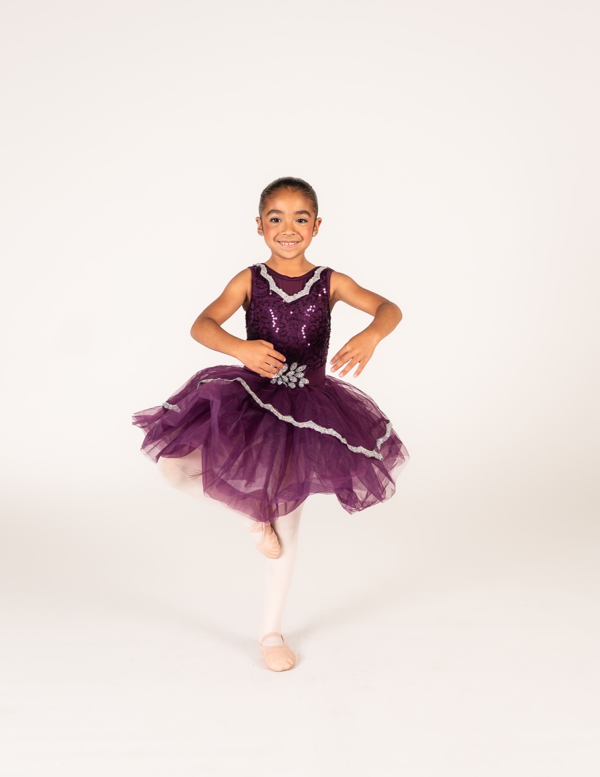 Ballet I dancer in a purple sequin tutu in a classical pose